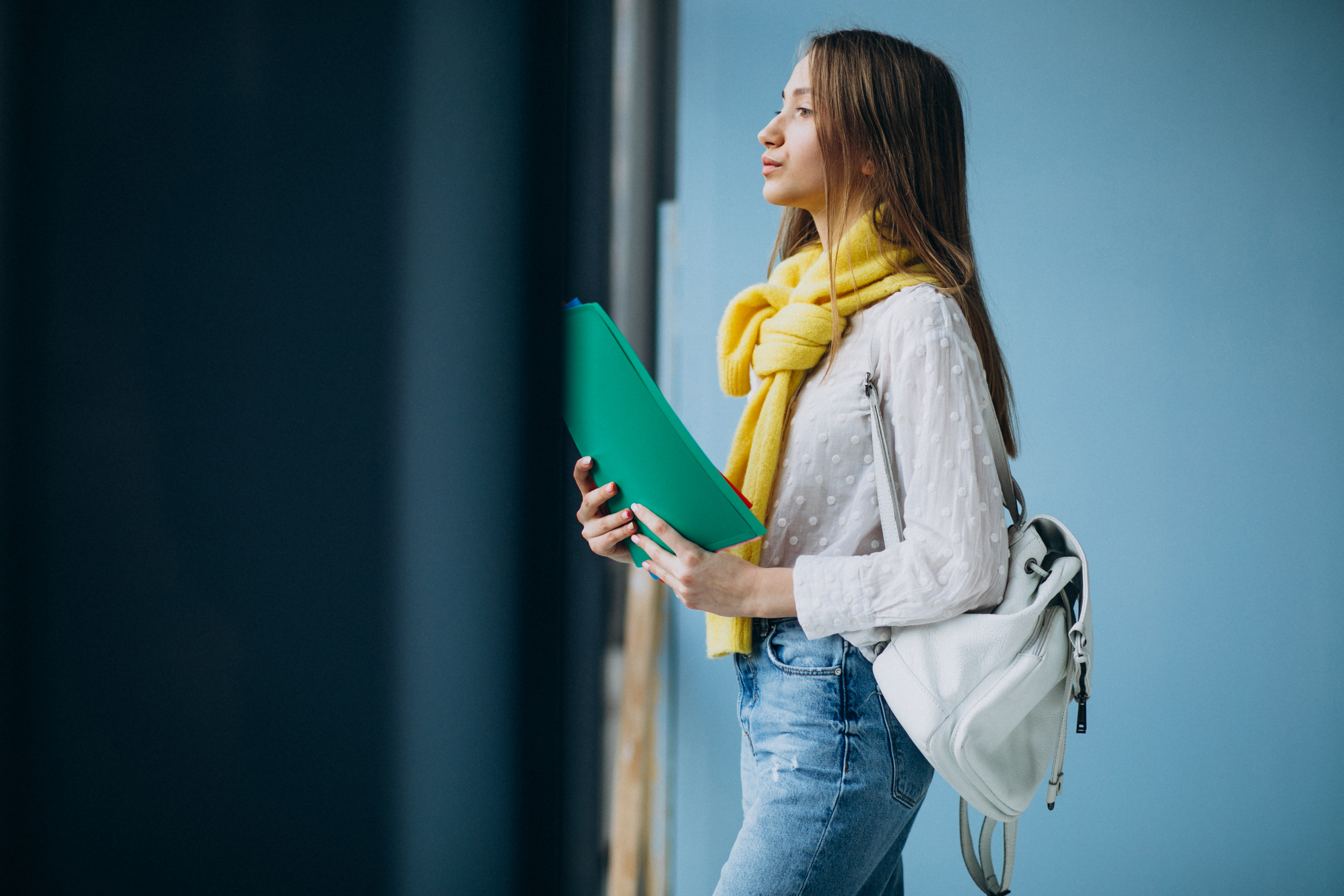 girl-student-standing-with-colorful-folders