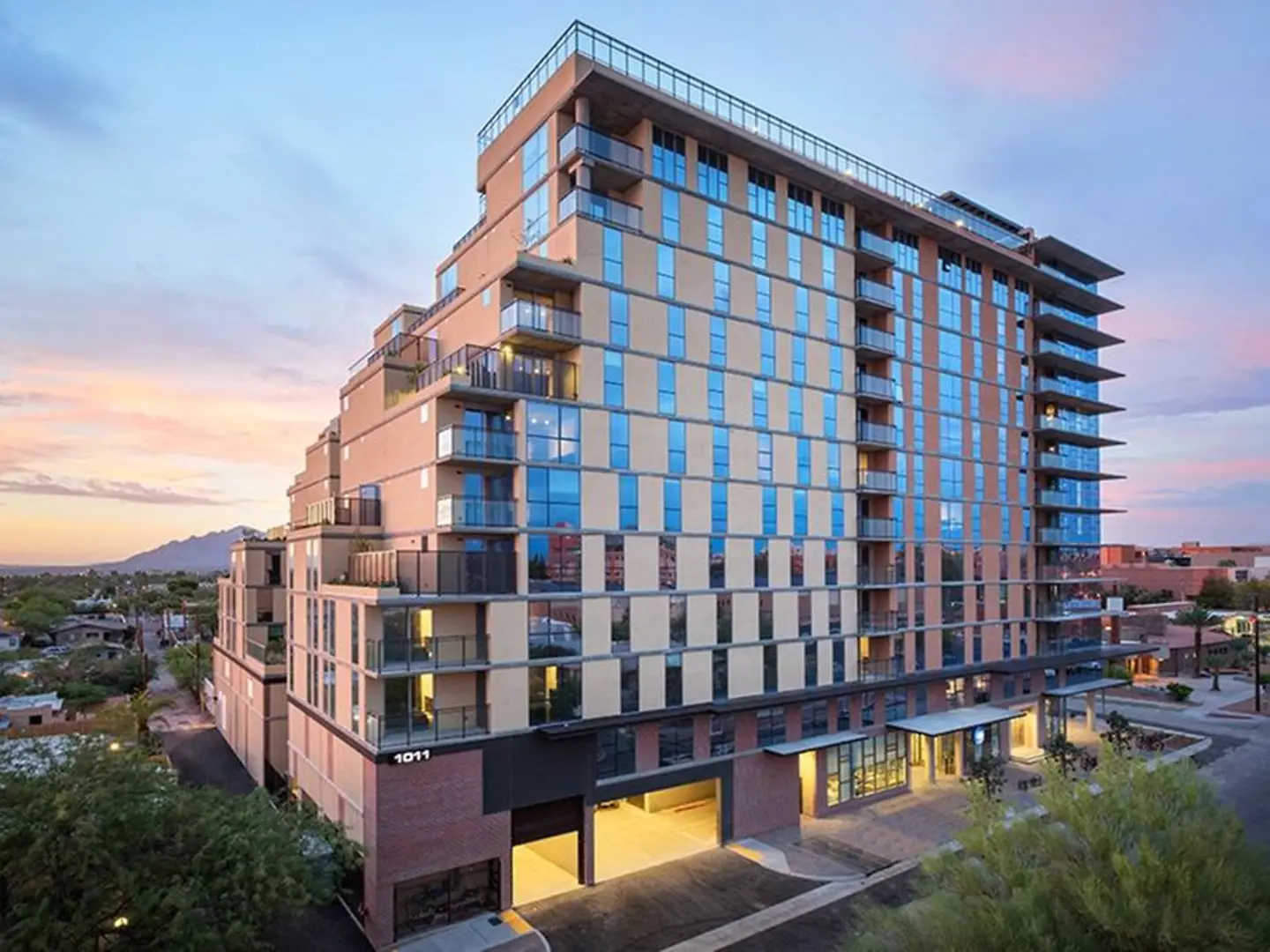Exterior of the apartment building at dusk.