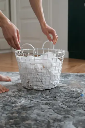 Person picking up laundry basket