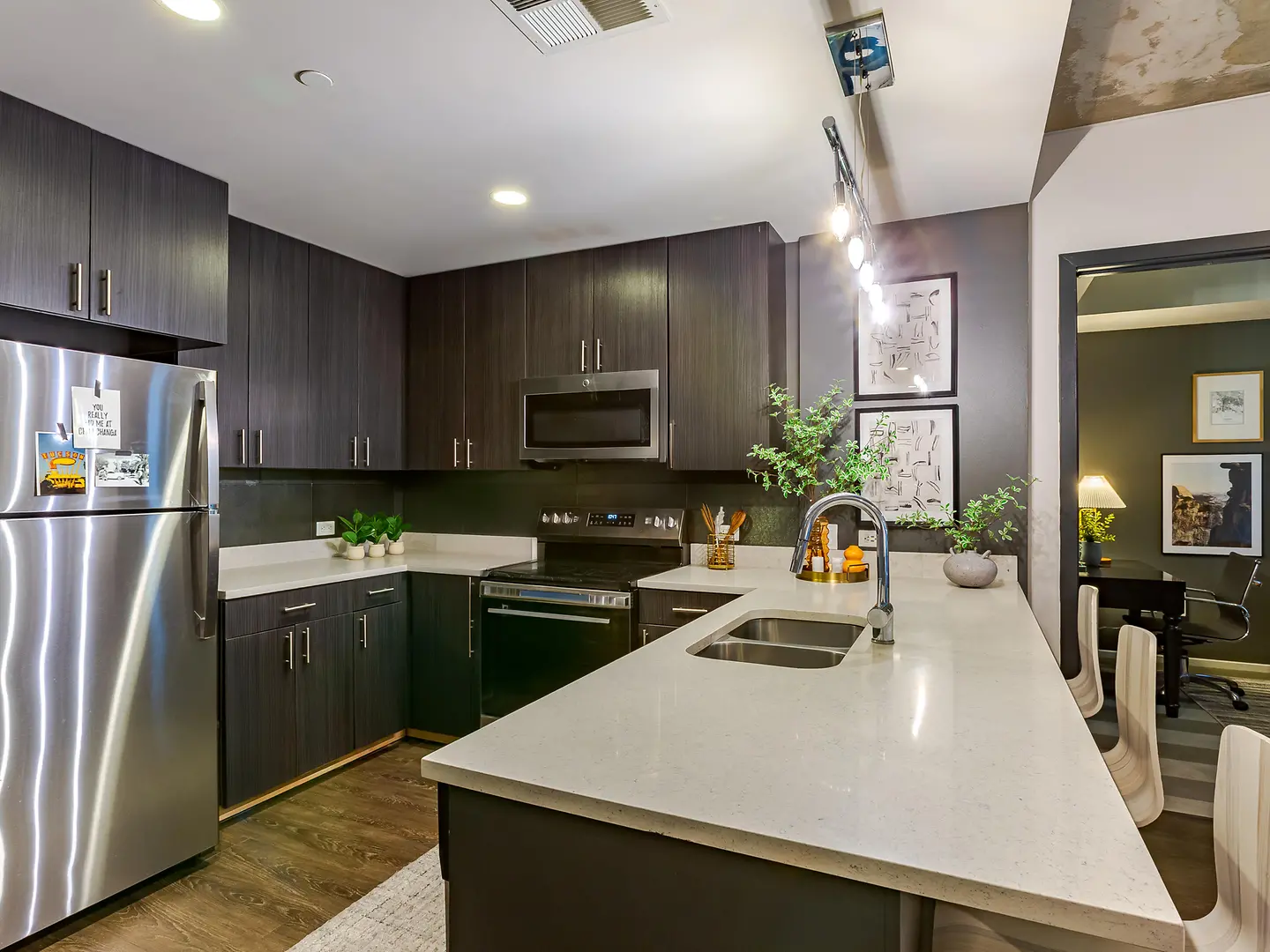 Model kitchen with a peninsula and stainless-steel appliances.