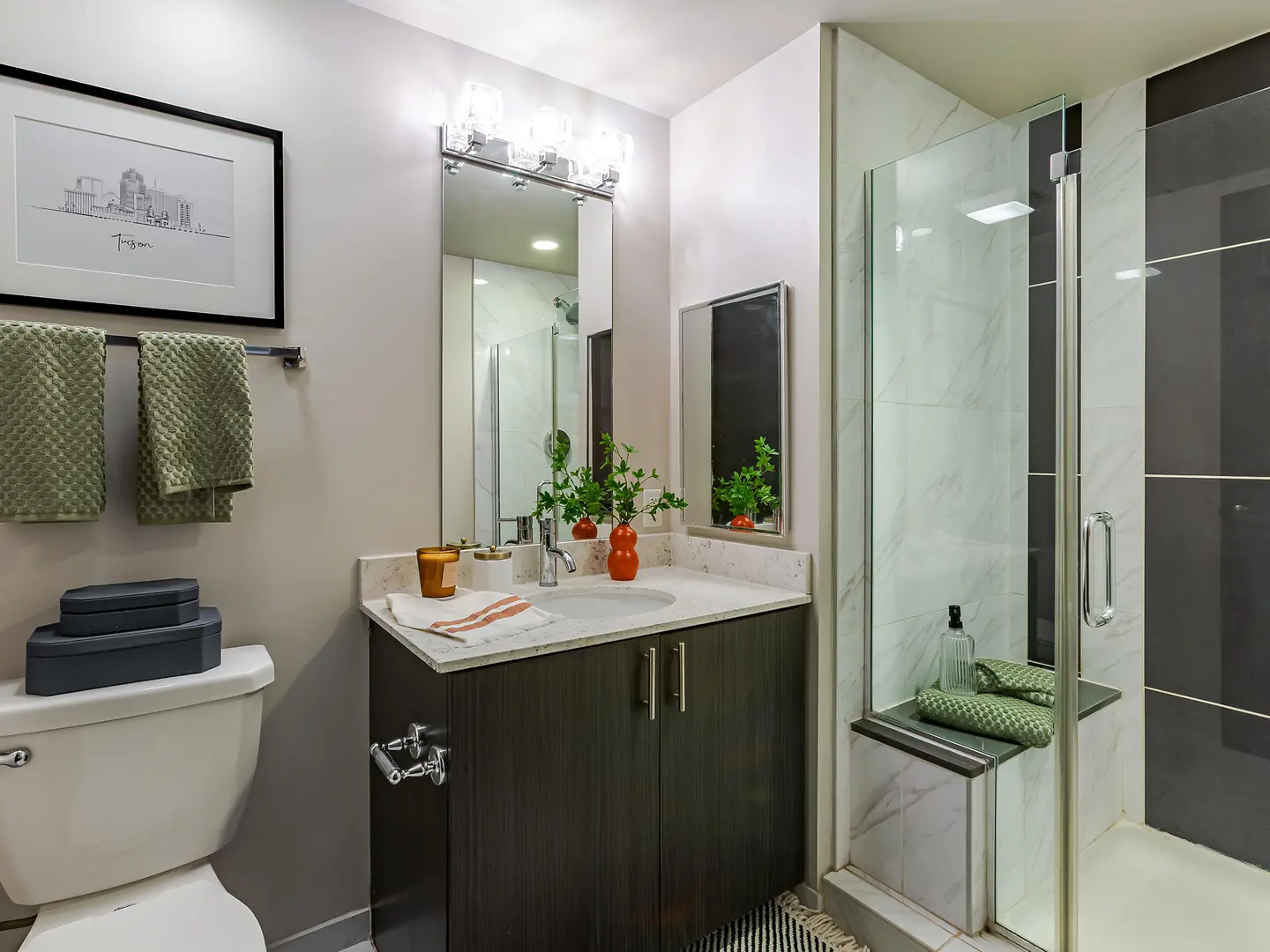 Model bathroom with a glass-enclosed shower.