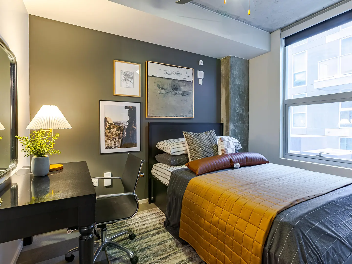 Model bedroom with a desk beside the window.